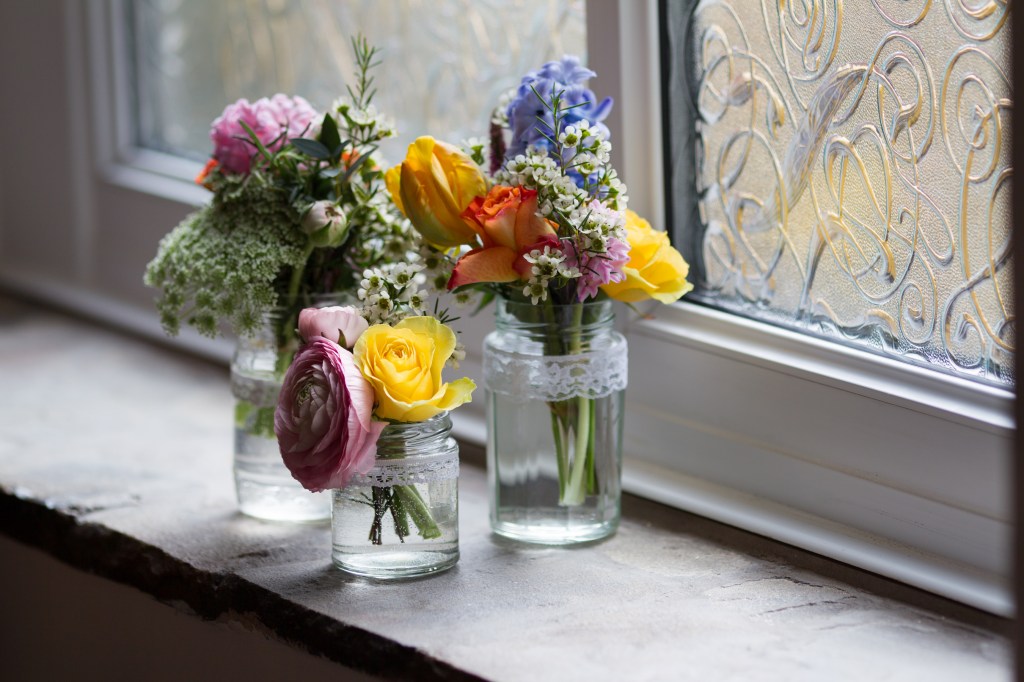 A picture of 3 vases of flowers on a window sill. Photo by Andrew Davies (c) Photoluminaire.
